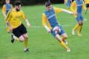 On the attack – Protech (blue and yellow) push forward in their 3-2 win over Woodys in division five of the Sceptre League on Sunday