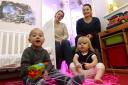Samuel Bethell, 2, at home in Colchester after successful operation, playing with sister Betsy, 1, with behind mum Vicki Gibson and Sarah Lloyd