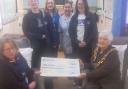 Fantastic - Mayor Jackie Pell giving the cheque to staff inside the  mobile cancer care unit