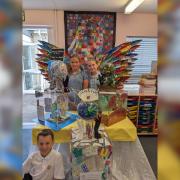 CREATIVE MINDS: Pupils pictured with one of the sculptures