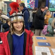 History fan - A St Peter's Primary School pupil wearing a Roman helmet at the exhibition