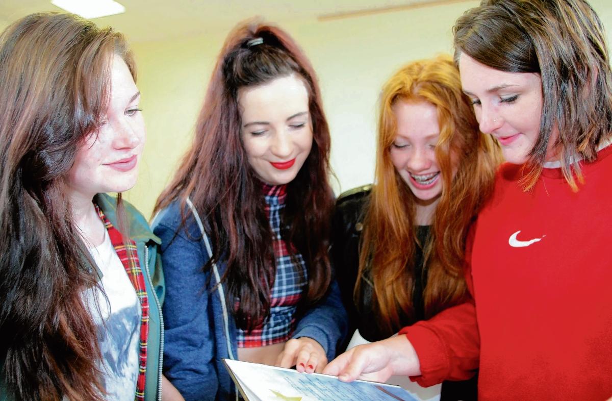 Madeline Lynch, 16, Hanna Taylor, 16, Flora Hook, 16, and Kiera Davies, 16, checking their grades at Ramsey College, Halstead