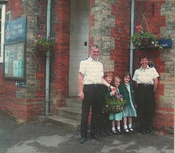 BLOOMING: PCSO Andrew Emery and Acting Inspector Bev Fenning accept hanging baskets from Gosfield school pupils Matthew Pavyer, Emily Barlow and Hattie Ayre in 2004 as part of Halstead in Bloom