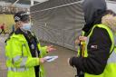 EDUCATING WORKERS: PC Gemma Horton hands out QR codes to workers at the airport's coach station (pic: Essex Police)