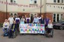 Celebration - Staff and residents at Colne View care home made a banner to welcome the Care UK cycling team (Care UK)