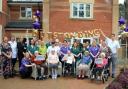 Staff and residents celebrate the outstanding rating outside Cedars Place