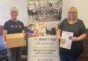 Delighted -  Essex Dementia Care, Care Manager Sharon Jones (on the right) receiving boxes of art therapy books