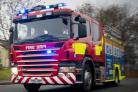 Firefighters battle raging fire caused by discarded cigarette