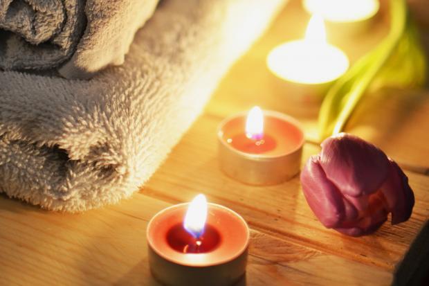 Halstead Gazette: A pile of towels, candles and a tulip. Credit: Canva
