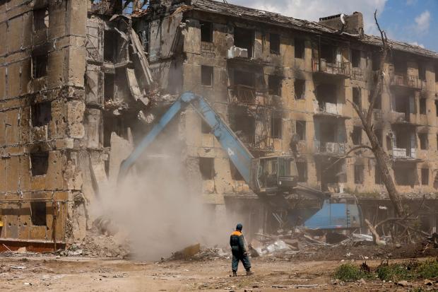Russian Emergency Situations Ministry workers disassemble a destroyed building in Mariupol, in territory under the government of the Donetsk People’s Republic, eastern Ukraine, Friday, May 27, 2022