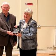 Deputy chairman Peter Caulfield presents Jackie Pell with the award