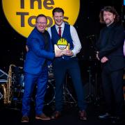 Mark Millar (left) presents the award to Tom on the evening which was hosted by Keith Farnan (right)