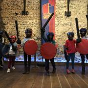 Young knights pictured with their swords and shields