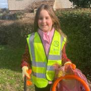 Volunteer - nine-year-old Summer picks up litter to help protect wildlife