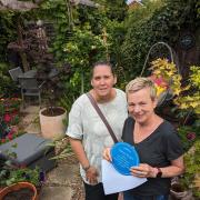 Tracy Rowe receives her award from Halstead in Bloom for winning the back garden category