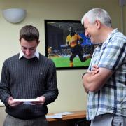 HAPPY FACE: Daniel Sharp has a read of his results