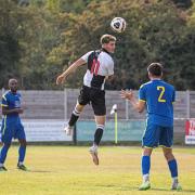 Leap: Halstead Town compete for a header against Woodford Town.