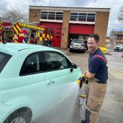 Raising funds - firefighter Steven Hill cleaning a car