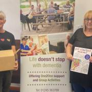Delighted -  Essex Dementia Care, Care Manager Sharon Jones (on the right) receiving boxes of art therapy books