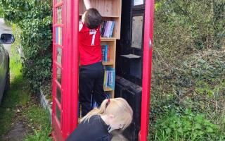Helpers - Iona's children have been involved in transforming the disused telephone box in Stambourne